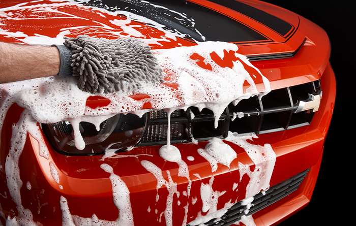 TONY'S ELITE MOBILE DETAILING expert washing red sports car 